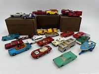 Full set of 16 vintage Lesney Matchbox toy cars and vehicles arranged with some on wooden blocks, showing variety.