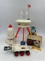 Main lot overview: base, rover, rocket capsule, figure, monitor, manual and accessories