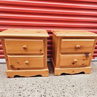 Front view of both nightstands side by side against red backdrop