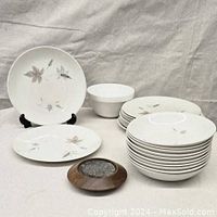 Photo of entire dinnerware set including plates, bowls, Maxwell Williams white bowl and teak spoon rest.