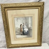 Frontal photo of the framed watercolor-style artwork depicting a woman and young girl in an ornate gilded frame with mat and glazing.