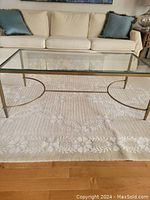 Front view of coffee table on rug against sofa