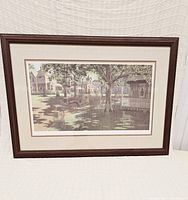 Full view of the framed print showing custom dark wood frame, matting, and visible artwork.