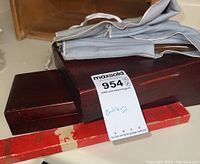 Photo of closed wooden boxes and fabric roll containing cutlery sets