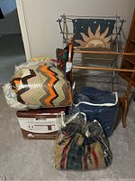 Front view of blankets and wooden drying/quilt rack with sun design fabric.