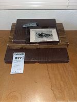 Photo showing three boxes, two closed and one with a fossilized stone on top and a card titled '30 Gemstones in the Rough'.