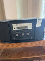 Front and top view showing the entire device with integrated speakers and control panel on the front.