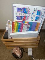 Wooden crate with reflexology charts behind and salt lamp in front