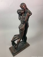 Bronze couple sculpture front angled view showing full figures and base.