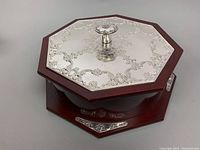 View of octagonal wooden base with sterling silver engraved lid and central knob in good condition