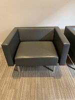 Single grey leather lounge chair front view