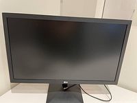 Front view of black LG monitor on stand showing the full screen and base.