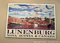 Art poster showing colorful harbor scene with sailboats and buildings titled 'LUNENBURG NOVA SCOTIA CANADA', mounted on plaque.