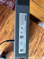 Top view showing the label on the bottom of the Bose portable speaker with model and safety certifications.