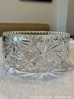 Side view of the crystal serving bowl showing detailed cut crystal patterns and thickness.