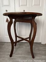 Full side view of antique harp leg table showing curved legs and cross braces, highlighting wood grain and structural design.