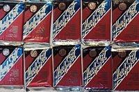 Close-up photo showing multiple factory-sealed 1993 Leaf Set baseball card packs with red and blue foil packaging, Leaf Set logo, and details about puzzle pieces and baseball cards inside.