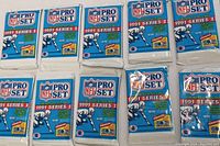 Ten sealed NFL Pro Set 1991 Series 1 trading card packs laid out, showing front design and packaging intact.