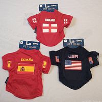 Photo showing three new pet jerseys with country names and flags: England, España, USA.