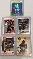 Front view of 5 Wayne Gretzky hockey cards showing player images and card designs.
