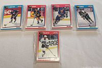 Five NHL hockey card sets featuring Dave Andreychuk, Ray Bourque, Brett Hull, Mike Modano, Wayne Gretzky in protective cases.