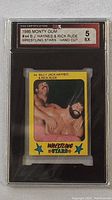 Front view of 1986 Monty Gum #44 wrestling card featuring B.J. Hayes and Rick Rude, graded EX 5 and encased in plastic holder.