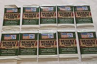 Top view showing the ten sealed Pro Set Desert Storm card packs arranged flat, distinct camouflage packaging visible.