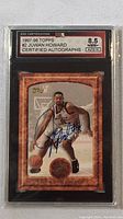 Front view of 1997-98 Topps #2 Juwan Howard basketball card, showing autograph and PSA grading slab with grades 8.5 NM+ and Auto 10