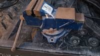 Front angle view of the blue 3-inch swivel base vise showing the wooden jaw covers and rust on metal parts.