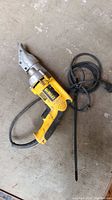 Full view of yellow DeWalt DW890 metal shear showing cord, handle, and shear head.