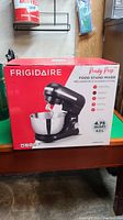 Frigidaire Ready Prep Food Stand Mixer in its original boxed packaging, showing the front of the box with product branding and 4.75 quart capacity.