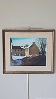 Full view of the framed pastel depicting a snow-covered building with a chimney and windows under a blue sky.