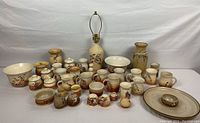 Full assortment of pottery items including mugs, bowls, cream & sugar holders, two vases, a lamp, and a large platter.