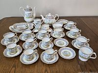 Front view of full tea and coffee service arranged on wooden table