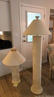 Overview photo of both ceramic lamps showing the size difference and textured base design