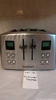 Front view of Cuisinart 4-slice toaster showing control panel with digital displays, buttons, and sliders.