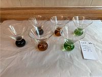 Full set of 6 martini glasses showing 2 black, 2 amber orange, and 2 green bases arranged in two rows.