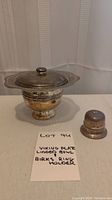 Photo of Viking plate copper lidded bowl next to Birks sterling silver ring holder with handwritten lot note