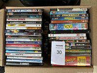 Box containing 75 assorted DVD movies stacked in two columns with visible titles across genres including comedy, drama, thriller, and animation.