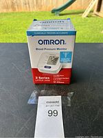 Boxed Omron 3 Series Upper Arm Blood Pressure Monitor showing front of package with product image and key features.