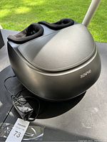Overall view of Renpho foot massager showing black casing and power cord.