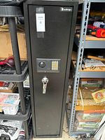 Front view of tall black safe with electronic keypad, key lock handle, and Zohop brand sticker visible.