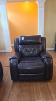 Front view of brown leather recliner showing overall condition