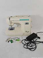 Full view of Brother Pacesetter PS-20 cream-colored sewing machine with foot pedal and accessories in front.