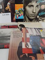 Photo showing multiple Bruce Springsteen album covers including The River and Born in the U.S.A.