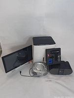 Full view of all items: Dell monitor, Frigidaire dehumidifier, two radios, and massage gun kit.