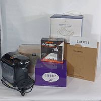 Overall photo showing all items in the set including coffee maker, diffuser box, lamp box, knee pillow box, massager box, and sheet set box.