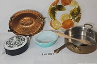 Overview of all items in the lot on white background, showing copper saucepan, two decorative bowls, Pyrex bowl, and lidded dish.
