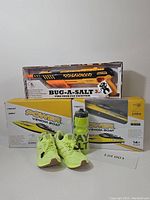 Full lot view showing Bug-A-Salt fly swatter, two Power Venom RC boats, Adidas shoes, and Stay Salty water bottle