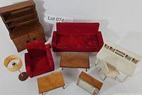 Full view of vintage doll furniture set showing main pieces including red couch and chair, coffee and side tables, desk with chair, hutch, TV, and floor lamp.